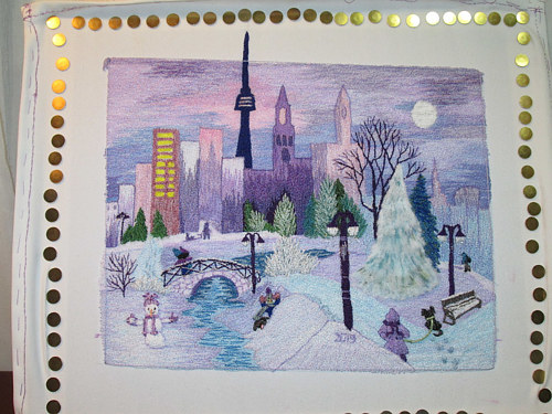 An embroidered artwork of a cityscape with a purple sky