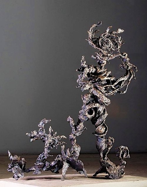 A series of tree or figure-like abstract bronze sculptures