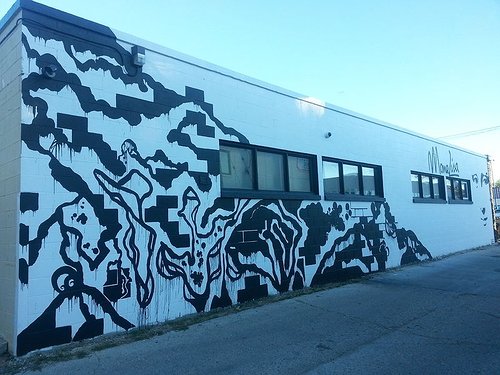 A blue wall mural that is an abstraction of the Mona Lisa