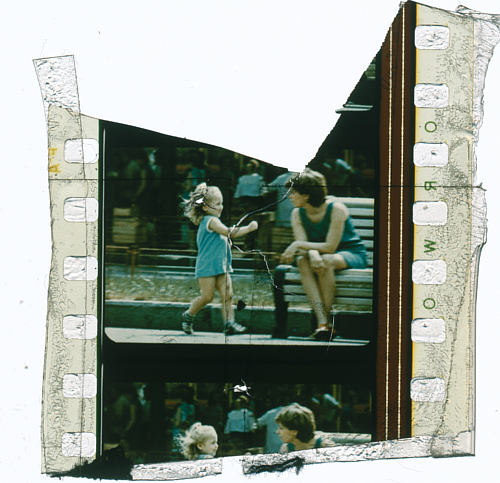 A fragment of a found film reel, with an image of a young girl playing