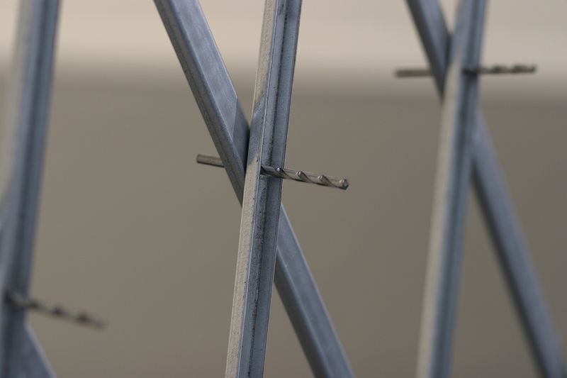 fix, (steel folding security gate with rivets removed and drill bits left in place) fix, (steel folding security gate with rivets removed and drill bits left in place) by Colby Brewer