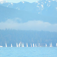 Mountains loom over the sailboats in English Bay, Vancouver //images.artistrunwebsite.com/gallery/img_1643581451910041_large.jpg?1556429583