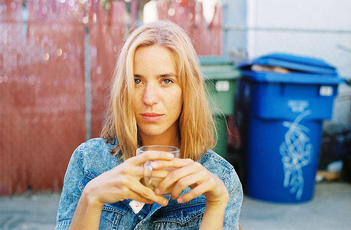 photo of blond woman holding a glass