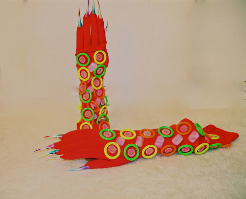A pair of gloves made with a variety of plastic objects